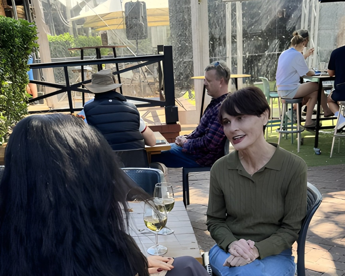 Adriana speaking with people outdoors at a community event